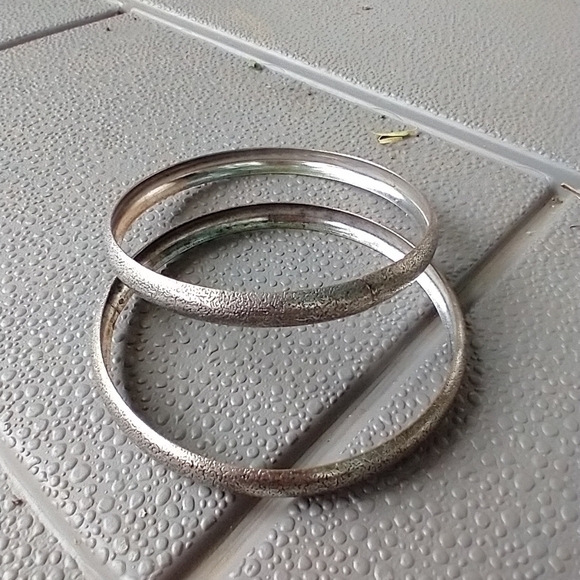 Set of 2 silvertone bangle bracelets. - Picture 2 of 2